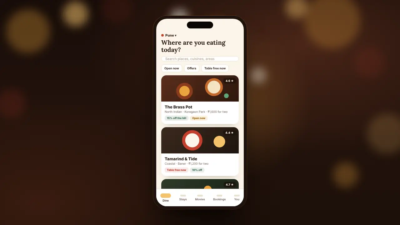 A phone showing the TableGenie app: places nearby, with their offers and whether they are open.